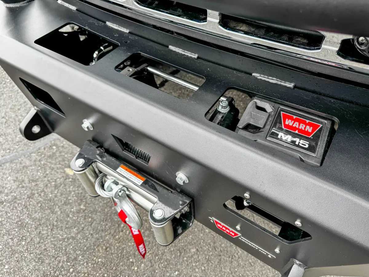 Driver-side front door open exterior view showing cab step and seat access.